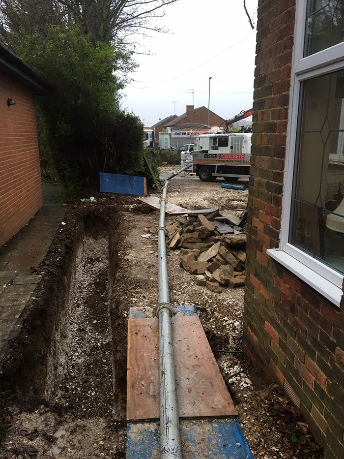 concrete pump, concrete truck, backyard, in the middle of a street